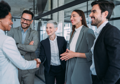 Business people shaking hands in the office. Business persons handshaking during a meeting in modern office.